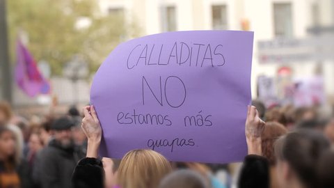 Poster with inscription in spanish. Shut up we are not prettier. Feminist Activists in a Demonstration. March for the International Day of Nonviolence against Women and Children in Barcelona, Spain