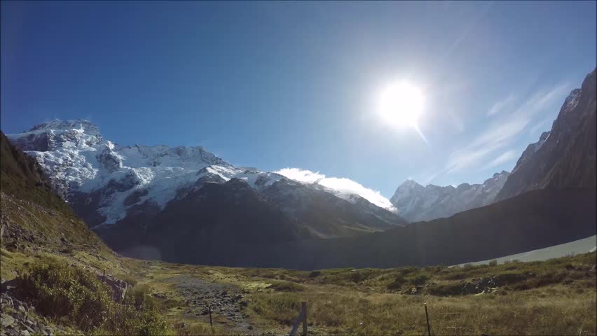 Timelapse mountain video from Hooker Valley walking track, Aoraki/Mount Cook National Park, South Island, New Zealand. Snow covered mountains, blue sky, moving clouds. Must visit in NZ.