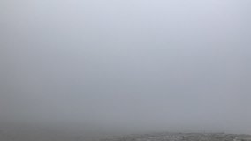 Time-lapse video: In the mountains during a snowstorm. Snow mist fills the surrounding space and dissipates again.
