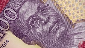 Nigeria 100 naira (2014) banknote rotating, Nigerian money close up. 4K UHD video footage