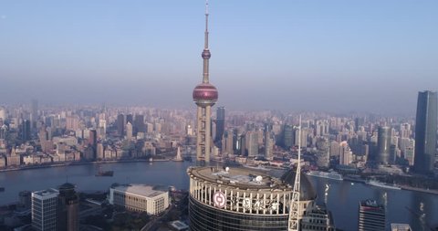 Shanghai China Circa-2017, daytime forwards tracking aerial view of the Shanghai pearl tower and cityscape