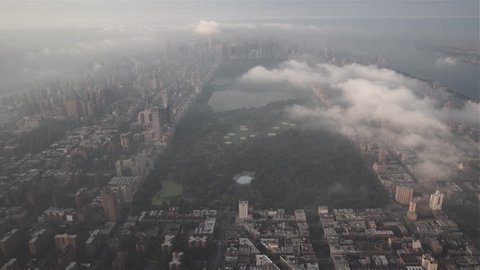 New York City Circa-2015, aerial view of Central Park from Harlem, with Upper East Side, Upper West Side and Midtown Manhattan covered in fog and low level clouds at sunrise