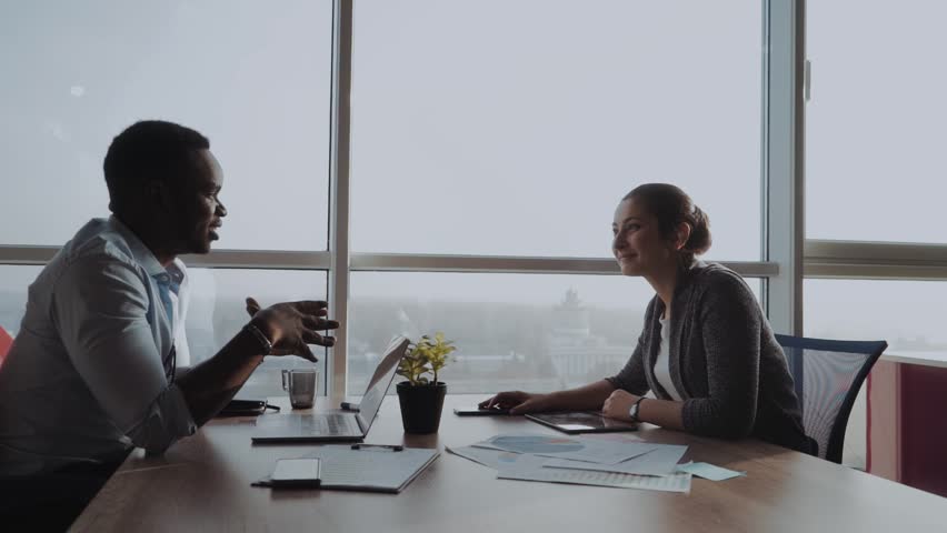 Two collegues working together in an office Royalty-Free Stock Footage #1020358354
