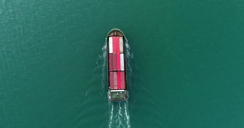 Aerial view of huge container ship floating in the sea. Shipping cargo to harbor, International transportation, Business logistics concept, Aerial view from drone.