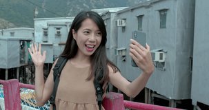 Woman take selfie in Tai O village of Hong Kong