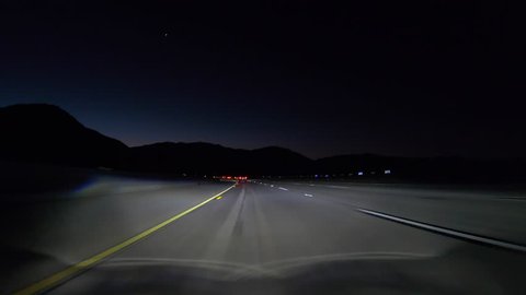 Los Angeles night freeway predawn driving through the Verdugo Hills on the 210 Freeway east near the San Fernando Valley.  