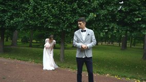 wedding couple fooling around in the Park and laughing