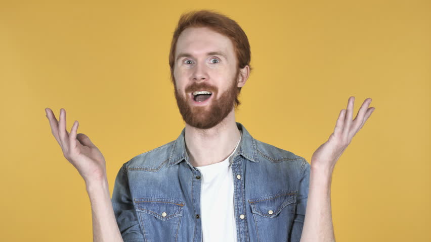 Wow, Happy Amazed Redhead Man Surprised by Gift Isolated on Yellow Background | Shutterstock HD Video #1020381403