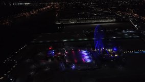 Aerial clip of Montreal during the night, with a Ferris Wheel in the frame.