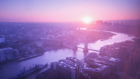 time lapse London skyline with illuminated Tower bridge and Canary Wharf in sunrise time, UK
