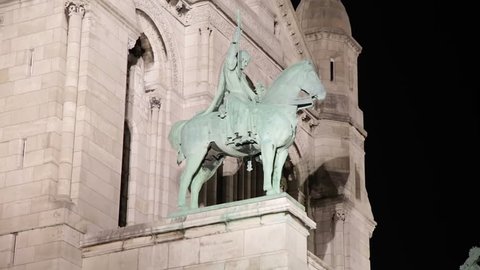 Paris, France - April 2018 : Statue of Basilica of the Sacre Coeur at night, also known as the Sacred Heart, the famous church in Montmartre in Paris France 
