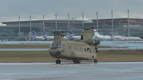 oslo airport norway - ca november 2018: military chinook helicopter ch47 us army taxiing on ground side and front view turning slow motion