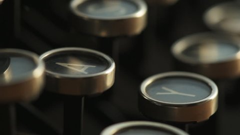 Finger typing on typewriter, close up slow motion with selective focus