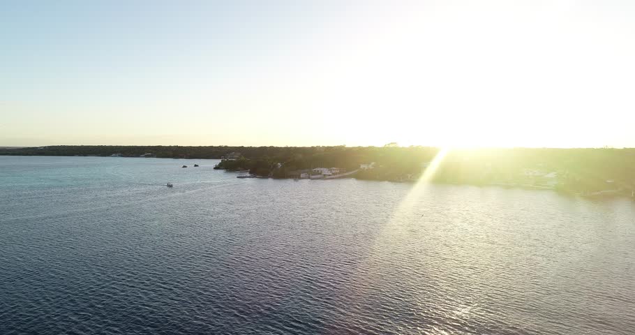 Boat navigating the lagoon at sunset