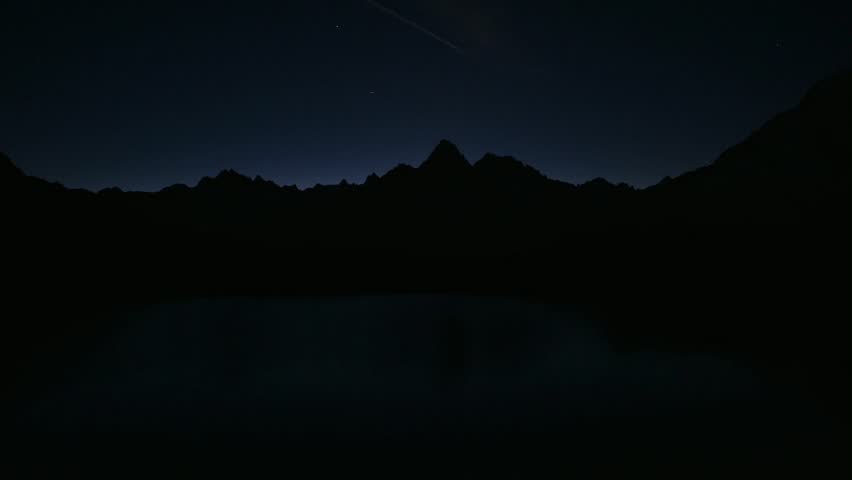 Picturesque night view of Chesery lake (Lac De Cheserys) in France Alps. Monte Bianco mountain range on background. Vallon de Berard Nature Preserve, Chamonix, Graian Alps. Timelapse video