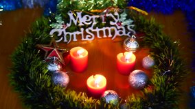 Footage of candle burning, balls and star Christmas. Merry Christmas
