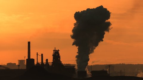 Global warming and climate change visual of heavy industry and smoke stacks