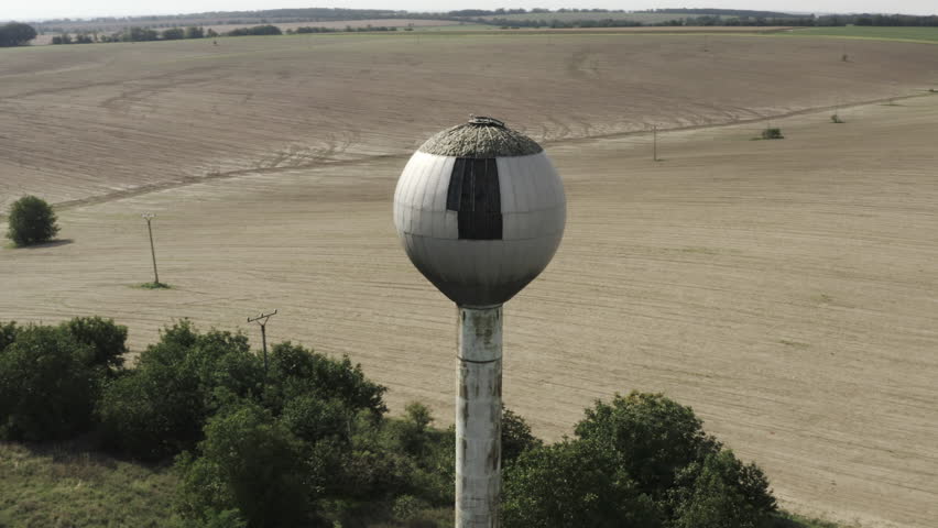Rotating Aerial view of old abandoned water reservoir tower