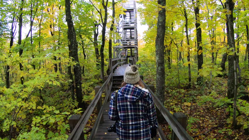 woman walking up to Summit Peak observation tower in Porcupine Mountains Park, Michigan