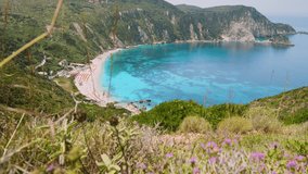 4k video of incredible beaches on Kefalonia Island. Mountains with lush greenery surrounding petani beach. clear blue water, picturesque scenic coastlines must-see destination