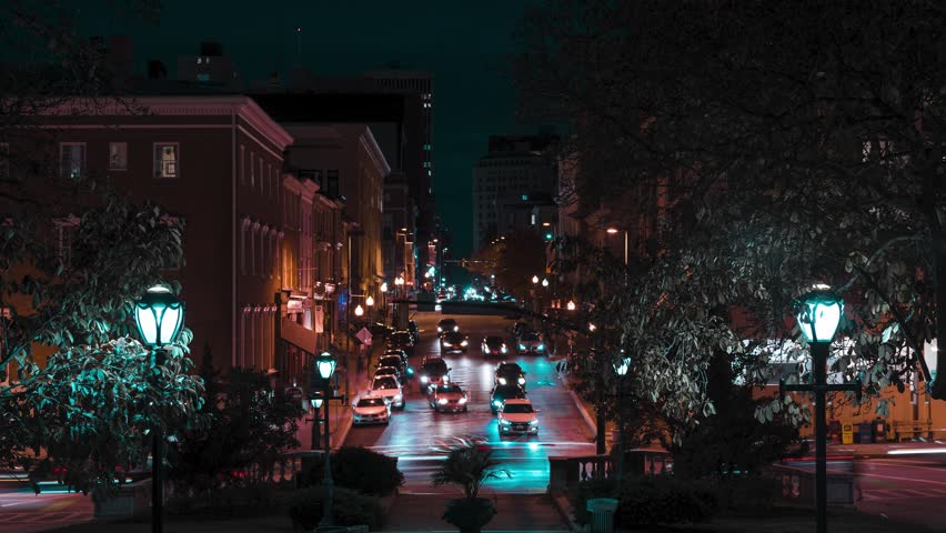 Night timelapse of cars going down a city avenue on North Charles street in Baltimore, Maryland