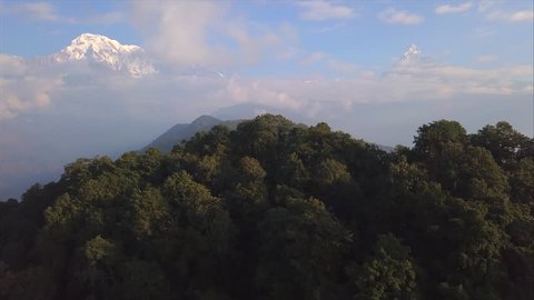 Fly cam open panoramic view on the Annapurna South and Machapuchare mountains. Mountain range of Annapurna conservation area in Nepal