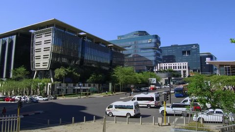 Johannesburg, South Africa, 28 November - 2018:Traffic passes in front of modern glass fronted office buildings.