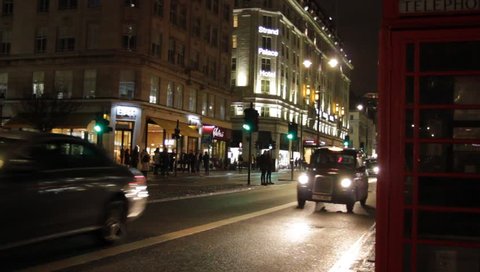 Taxi, Bus, London UK -  Feb 13th 2019: black taxi cab bus red phone box on the Strand road night London England . Tourism  landmark vacation holiday spot London black cab stock, footage, video, clip