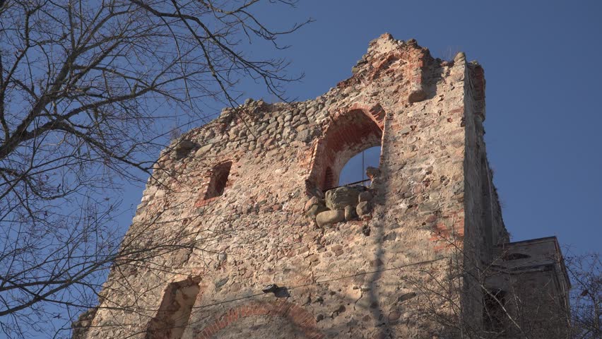 Retro architecture and the antique building. Castle ruins construction with the large stone wall. Country of Latvia, city Dobele. Livonia Order 13th century palace.
