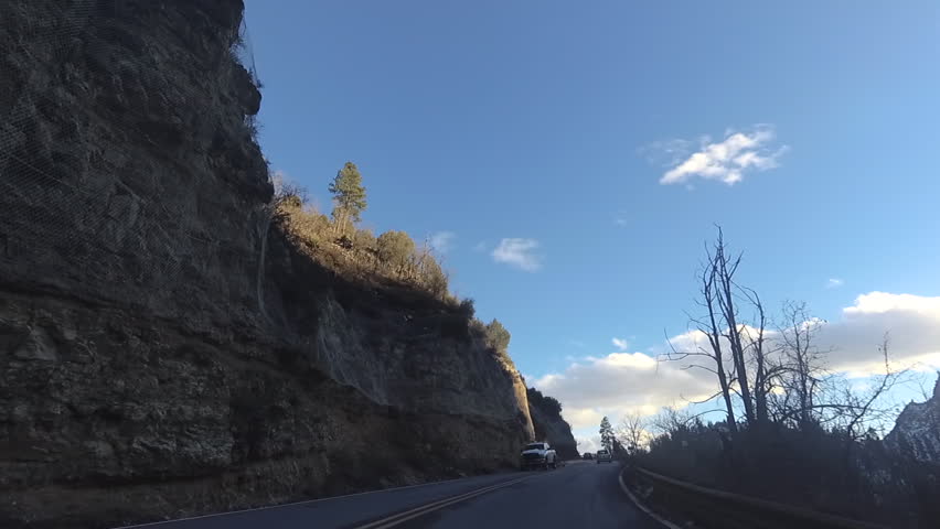 Arizona Route 89A Sedona to Flagstaf, driving footage of switchbacks, winding,,icy road condition and blue sky.