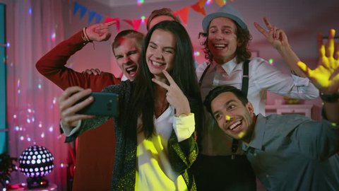 Happy Group of Young People Taking Collective Selfie at the Wild House Party. Neon Lights, Disco Ball and Funny Costumes.
