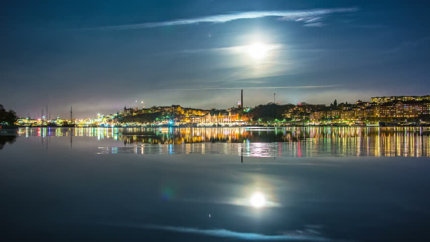 Stockholm Södermalm cityscape skyline at night Time Lapse. Beautiful moonlight and reflections in the water