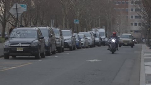 Hoboken, NJ / USA - 12 02 2018: motorcycle and cars moving on road in town