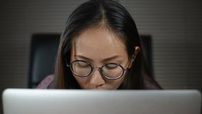 Close up of asian woman using laptop computer
