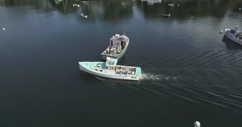 Rockport, Maine / United States - 09 22 2017: ROCKPORT, MAINE, SEPTEMBER 2017 - A blue boat passing through Rockport Harbor, Maine.