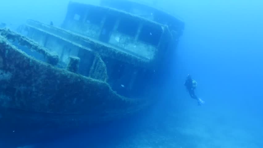 Scuba divers exploring ship wreck underwater wreck dive | Shutterstock HD Video #1020481849