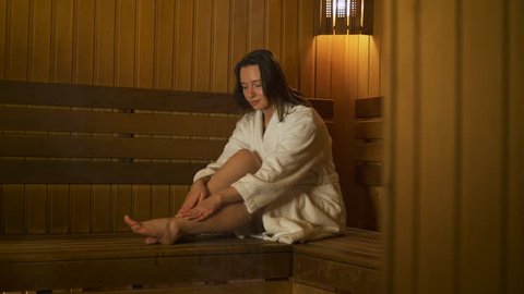 Rest of the young woman in the sauna