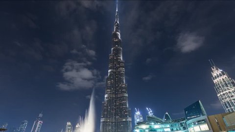 Dubai, United Arab Emirates - November 11, 2018: Timelapse hyperlapse of Burj Khalifa skyscraper tower. The tallest building in the world. Filmed at night with fountain in front. UAE