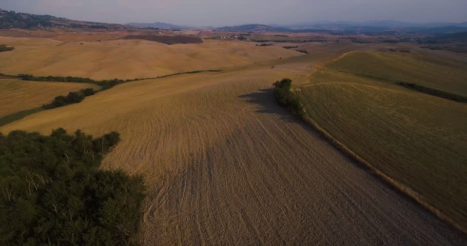 Aerial, gorgeous tuscan fields landscape near the city of Volterra