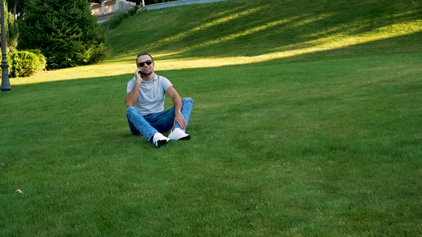 Happy smiling young father and daughter playing in the park
