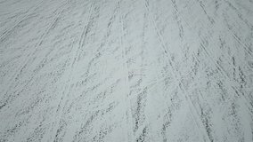 Aerial view of a field of winter wheat covered with white snow. Natural background. Top view