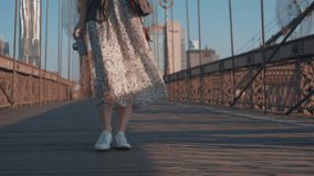 Young girl in a dress on the Brooklyn Bridge