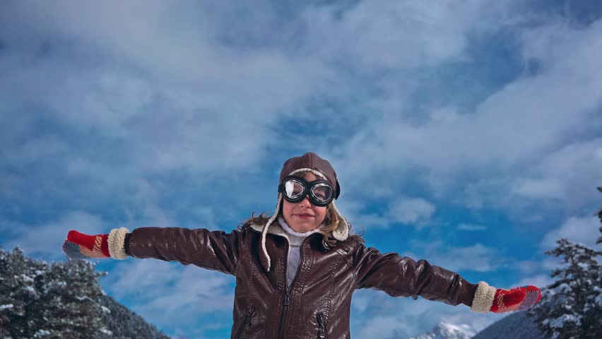 Happy child pilot in winter. Kid having fun outdoor. Travel and adventure concept. Dream and imagination