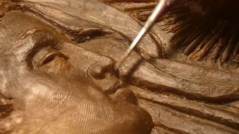 Milan, Italy/Italy - November 2018: , Hands shaping a Face of the Madonna in Beeswax using suitable tools,  Francesco Violi Sculptor. Filmed with PANASONIC FZ82 