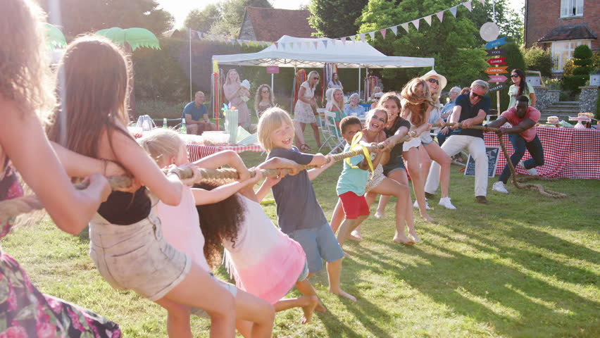 Slow Motion Shot Of Game Of Tug Of War At Summer Garden Fete Royalty-Free Stock Footage #1020498130