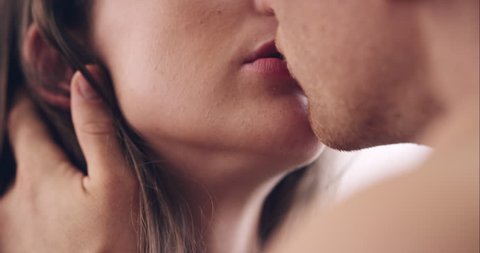 Close up of Attractive young couple kissing engaged in foreplay touching each other