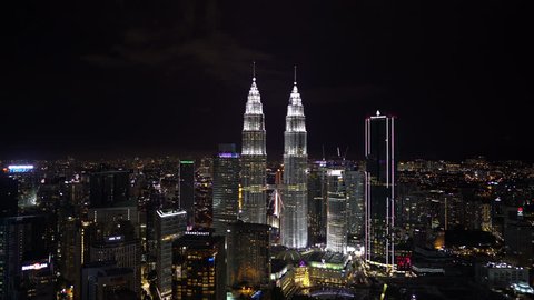 Kuala Lumpur, Malaysia - December 1, 2018: 4k b roll establishing shot of Kuala Lumpur city skyline aerial view at dusk with Petronas Twin Tower, KL Tower, Four Season, Hyatt and Banyan Tree Hotel.