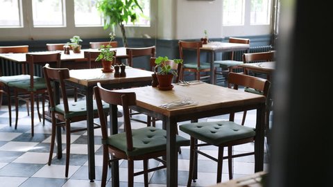 Empty Restaurant Interior With Tables Set For Service: film stockowy