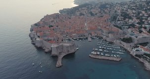 DUBROVNIK, CROATIA - 2018 : Aerial view of Dubrovnik cityscape at sunset with boats and the sea in view
