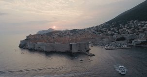 DUBROVNIK, CROATIA - 2018 : Aerial view of Dubrovnik cityscape at sunset with boats and the sea in view